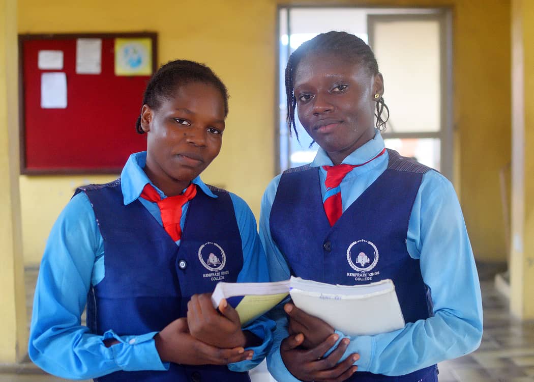 KKC students in official sky blue and navy uniform reading together